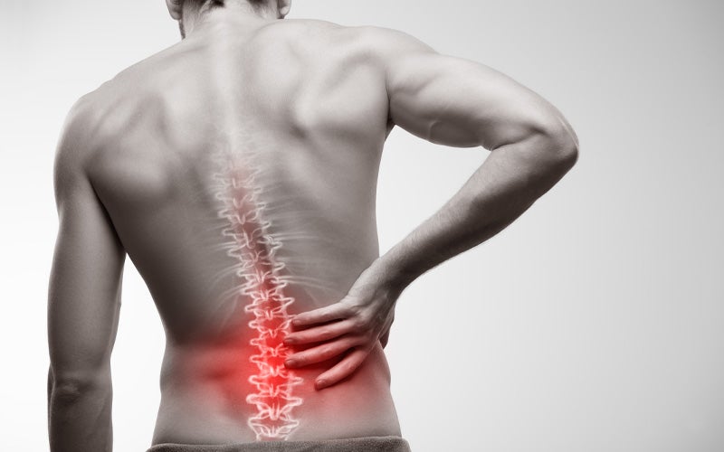 Man with back pain and a highlighted spine illustration